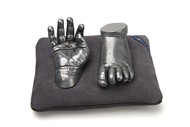 Aluminium cold cast baby hand and foot on grey cushion